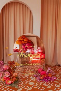 an arrangement of flowers and balloons in front of a marquee with the words marriage on it