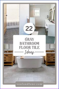 a bathroom with gray tile floors and white fixtures, including a bathtub in the center