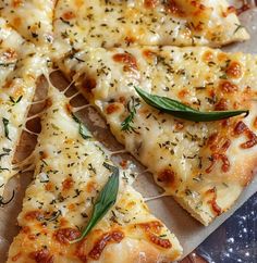 a pizza with cheese and herbs cut into slices