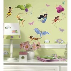 wall decals with tinkerbells and flowers on the side of a dresser