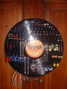 a record with many different earrings hanging from it