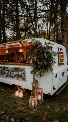 an old camper converted into a mobile bar with plants growing out of the back