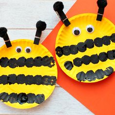 two paper plates with faces made to look like bees