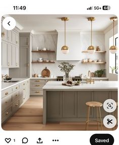 an image of a kitchen with white cabinets and gold accents on the countertops, along with two stools