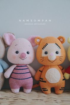 three stuffed animals sitting next to each other on a shelf