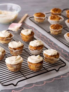 cupcakes with frosting sitting on top of a cooling rack