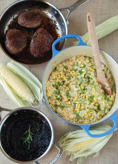 corn, sausage and other foods are being cooked in pans on the table with utensils