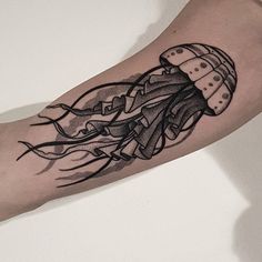 a black and white tattoo of a jellyfish