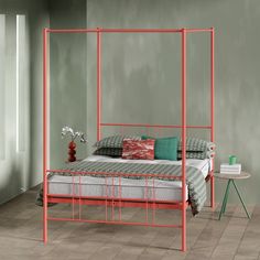 an orange metal bed frame in a bedroom