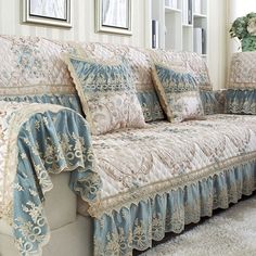 a couch covered in blue and white lace