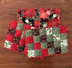 These extra-large hot pads (10.25" x 15.25") are generously sized for standard casserole dishes, they're reversible, and they make great Christmas and Hostess gifts! These charming patchwork trivets are sized to sit under casserole dishes or at your Coffee Station. They can also be used as a centerpiece, table topper, or placemat and will protect the surface of your table while adding a bright design to your kitchen.  There are two versions of this Christmas Poinsettia Casserole Mat -- one is predominantly Red, the other Green -- your choice.  Both have the same Large Red Poinsettia on Black fabric with gold metallic accents on the reverse side. They are made with four layers.  All my potholders/trivets are made with one layer of Insul-Bright and a second layer of 100% cotton batting to pr Quilted Trivet, Quilted Potholders, Red Poinsettia, Centerpiece Table, Bright Design, Christmas Poinsettia, Hot Pad, Coffee Station, Table Topper