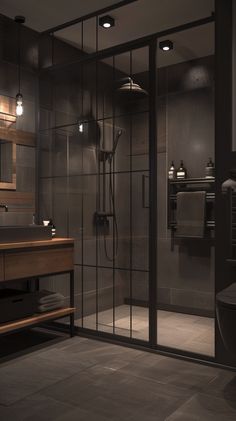 a bathroom with a sink, mirror and shower stall in the corner is shown at night