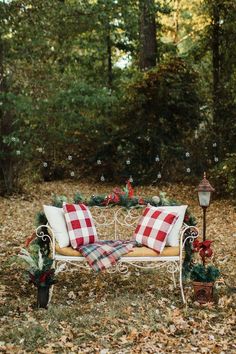 a white bench sitting in the middle of a forest