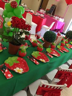 a table set up with plates, flowers and balloons