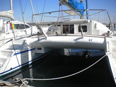 a sailboat docked in the water with other boats