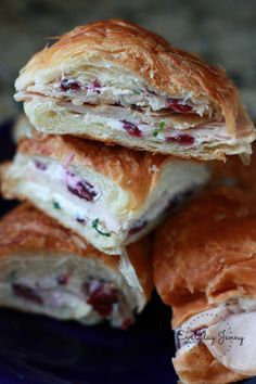 three cranberry sandwich halves stacked on top of each other in a blue plate