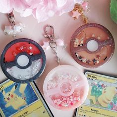 some pokemon themed items are sitting on a table next to pink flowers and other accessories