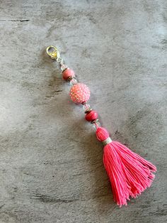 Pink tassel charm  This tassel with beads is made up of unique beads and handmade tassel with a lobster clasp attached. This charm would make a great accessory for any bag or planner. This charm would make a great gift for someone special. This charm is about 7.25 inches long   This listing is for the purse charm only. Bag and photo props are not included.  Please feel free to message me with any questions or custom orders Gift Beaded Dangle Tassel Necklace, Beaded Dangle Tassel Necklace For Gift, Beaded Tassel Dangle Necklace For Gifts, Handmade Dangle Tassel Necklace For Gift, Tassel With Beads, Pink Tassel, Purse Charms, Pin Badges, Photo Props