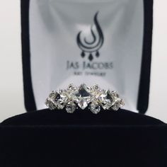 two engagement rings sitting on top of a velvet box