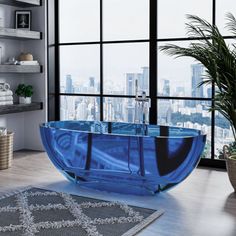 a blue bath tub sitting next to a large window