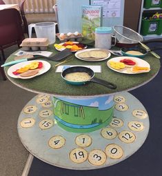 a table topped with lots of food on top of a green mat covered in letters