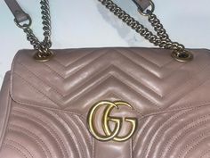 Gucci Marmont Dusty Pink Bag Retails $2550 plus tax, purchased at the Gucci store at the airport in Germany couple of years ago. This bag used and well loved. Most of the wear shows on the flap, the corners do have some wear too and the logo is kinda faded but it shows mainly because of the flash. The inside does show some wear and has some pain marks. Please review the pictures for the wear on the bag.  Bag still has a lot of life The small GG Marmont chain shoulder bag has a softly structured shape and an oversized flap closure with Double G hardware. The sliding chain strap can be worn multiple ways, changing between a shoulder and a top handle bag. Made in matelassé chevron leather with a heart on the back. Dusty pink matelassé chevron leather with heart Antique gold-toned hardware Dou Dusty Pink Bag, Gucci Store, Gucci Marmont, Gg Marmont, At The Airport, Chain Shoulder Bag, Bag Bag, Heart On, Handle Bag