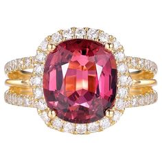 This exquisite ring is a stunning piece of jewelry crafted in luxurious 18-karat yellow gold. At its center is a captivating 4.01-carat cushion-cut tourmaline, displaying a rich and vibrant hue that draws the eye. The tourmaline is elegantly framed by a halo of sparkling diamonds, totaling 0.75 carats, which enhance its brilliance and add a touch of opulence. The band features a delicate pavé setting of diamonds, creating a continuous shimmer that complements the central gemstone beautifully. Th Fancy Diamond Ring, Yellow Diamond Rings, Warm Yellow, Diamond Cocktail Rings, Fancy Diamonds, Modern Ring, The Dazzling, Pink Ring, Elegant Ring