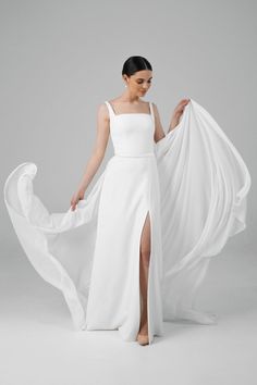 a woman wearing a white dress with a slit in the side