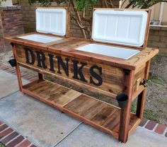 two coolers sitting on top of a wooden table with the words drinks written on it