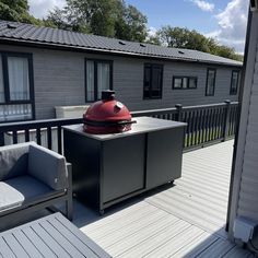 a bbq grill on the back deck of a house