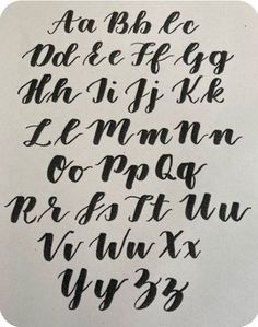 some type of calligraphy that has been written in black ink and is on white paper