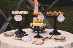 a table topped with cakes and desserts on top of it