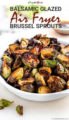 a white bowl filled with brussel sprouts on top of a table