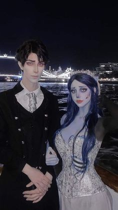 a couple dressed up as corpse bride and groom on a boat in the water at night