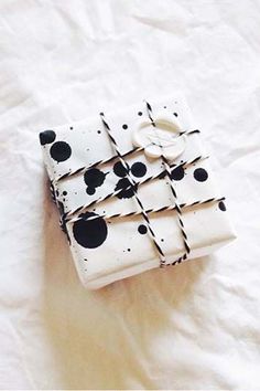 a white and black box sitting on top of a bed