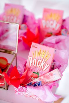 a pink box filled with candy on top of a table