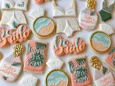 decorated cookies with bride and groom's names are displayed on a white tablecloth