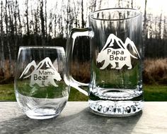 two glass mugs with the words papa bear and mama bear on them sitting next to each other