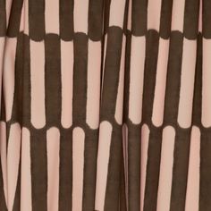 the curtain is brown and white with black dots on it's edges, as well as pink stripes