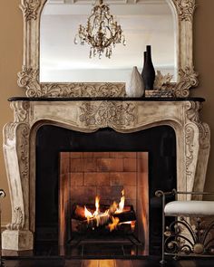 a fire place with a mirror above it