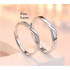 two white gold wedding rings with diamonds on each side and the words free laser above them