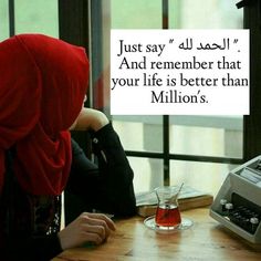 a woman sitting at a table in front of a typewriter with a red scarf on her head