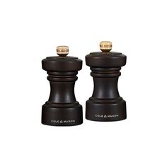 two black and gold salt and pepper shakers sitting side by side on a white background