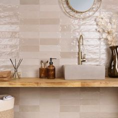 a bathroom counter with two soap dispensers and a mirror on the wall