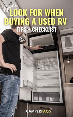 a man looking into an open refrigerator with the words, look for when buying a used rv tips - checklist