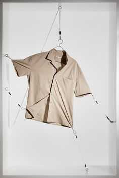 an unbuttoned shirt hanging from a string