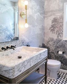 a white sink sitting under a bathroom mirror next to a black and white checkered floor