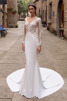 a woman in a wedding dress standing on the street