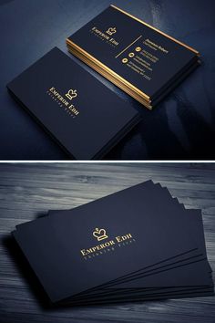 some black and gold business cards are stacked on top of each other, with the same logo