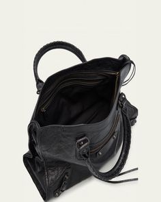 Balenciaga "Le City" top handle bag in lamb leather     Rolled top handles     Detachable, adjustable shoulder strap    Can be worn as a top handle or shoulder bag     Zip top closure     Exterior, front zip pocket     Interior, one zip pocket     Approx. 9.2"H x 14.6"W x 5.9"D    Wipe clean    Made in Italy Designer Hobo Bag Satchel, Designer Satchel Shoulder Bag With Zipper, Designer Satchel Shoulder Bag, Designer Satchel Shoulder Bag With Zipper Closure, Designer Tote Shoulder Bag With Zipper, Business Hobo Bag With Top Carry Handle, Designer Hobo Bag With Double Handle And Adjustable Strap, Designer Satchel With Zipper Closure For Everyday Use, Designer Satchel With Zipper For Everyday Use